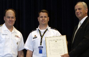 In June, Rear Adm. John Christenson, USN (l), president of the Naval War College, and Joe Ducas (r), chapter president, congratulate Lt. Col. Francisco DeCarvalho, USA, on winning first prize in the Information Operation Category for the chapter's essay content.